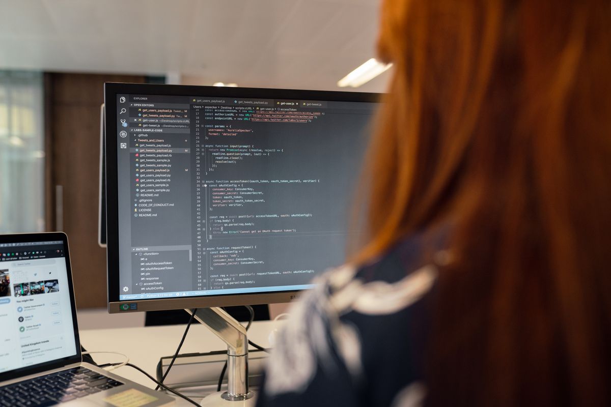 Developer reviewing custom application code on a monitor